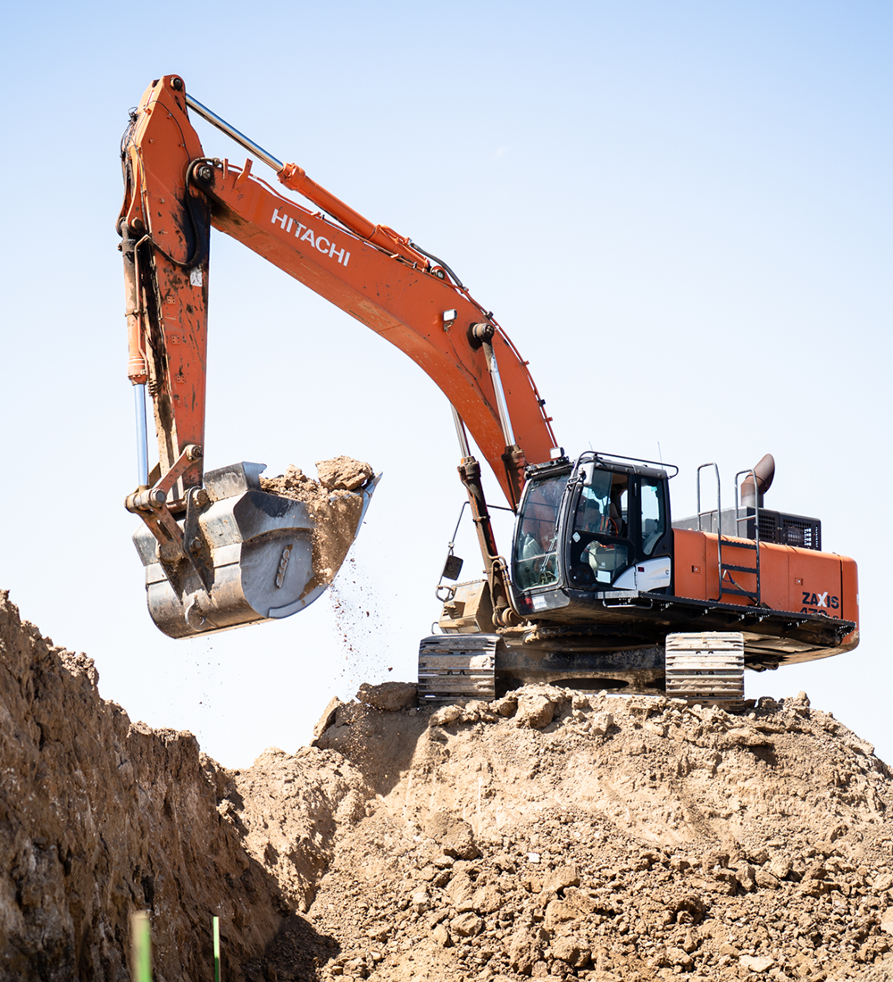 Hitachi Equipment Moving Dirt at Earthwork Job Site